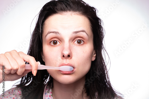beautiful young woman cleaning teeth