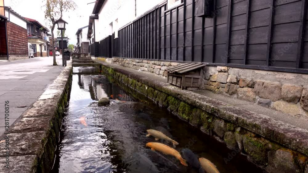 Setogawa canal with carps along white walled storage street, Japan Setogawa canal with carps along white walled storage street, Japan