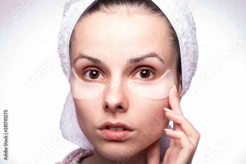  beautiful young woman in a towel on her head and with patches on her face