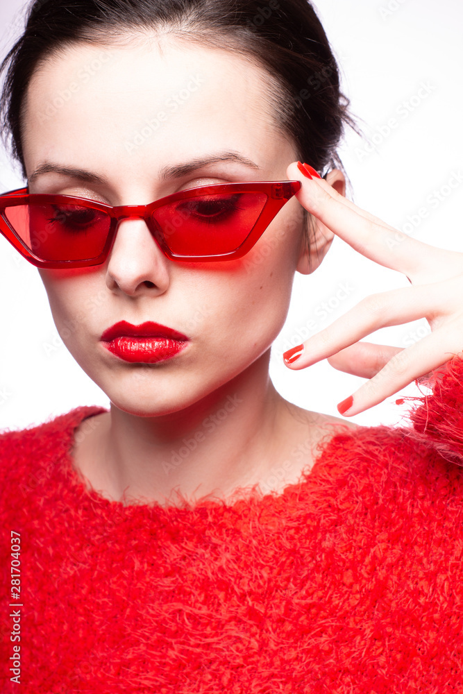 young woman in red sunglasses, red nails, red lipstick young woman in red sunglasses, red nails, red lipstick