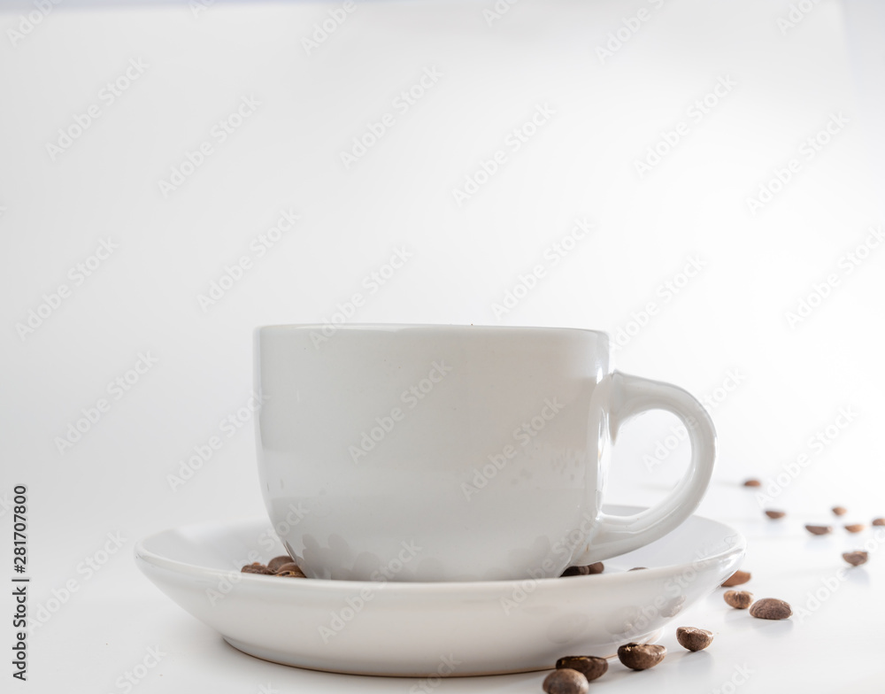 Coffee beans fall into a white porcelain cup and saucer, bouncing and jumping through the air conveying alert excitement, all isolated against a white background Coffee beans fall into a white porcelain cup and saucer, bouncing and jumping through the air conveying alert excitement, all isolated against a white background