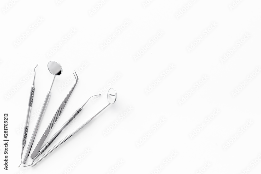 Fototapeta premium Dentist tools for cure teeth on white background top view copy space