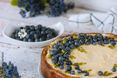 Baked blueberry cheesecake with blueberries and pumpkin seeds