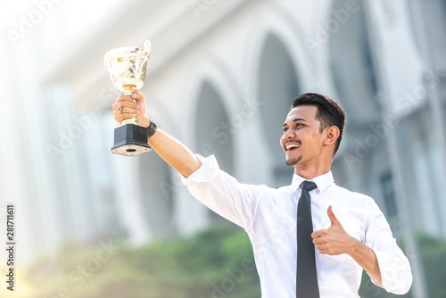 Malay Businessman wins a trophy. Top employee concept photo