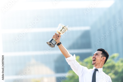 Malay Businessman wins a trophy. Top employee concept photo