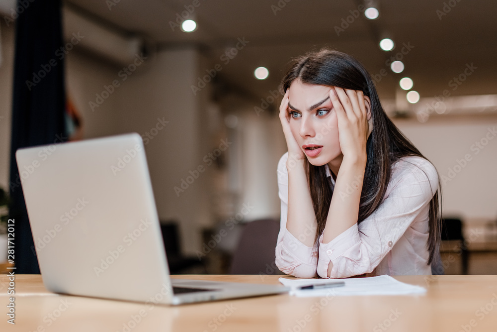 tired woman in the office at her desk with laptop tired woman in the office at her desk with laptop