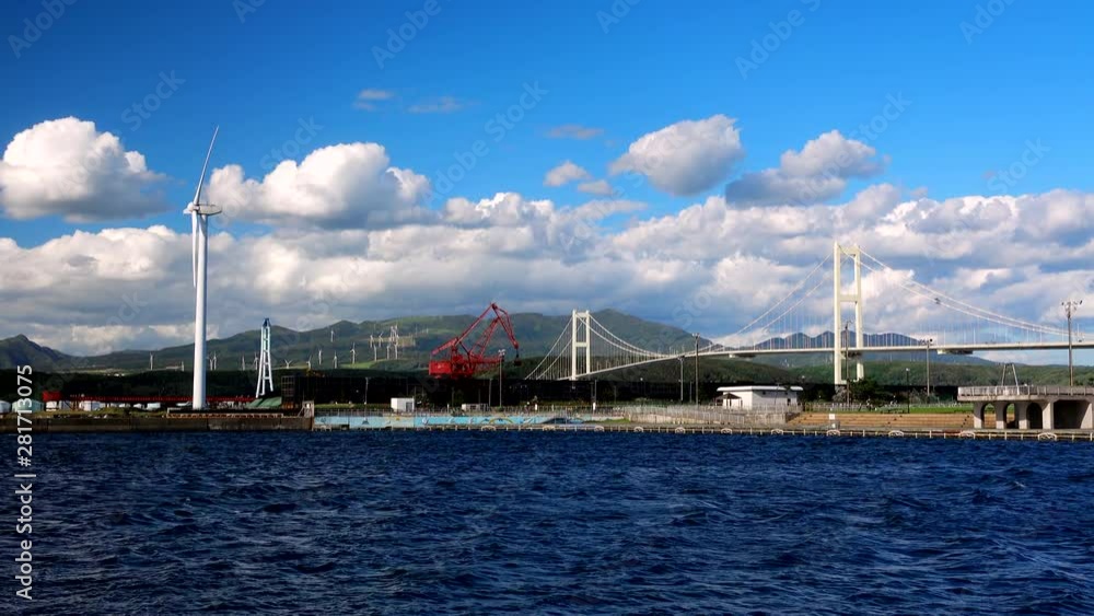 View of lake and wind turbines, Muroran, Hokkaido, Japan