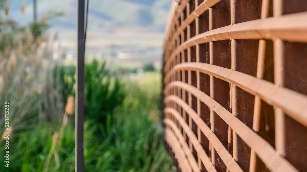 Fototapeta premium Close up of the brown metal lattice guardrail of a bridge on a sunny day