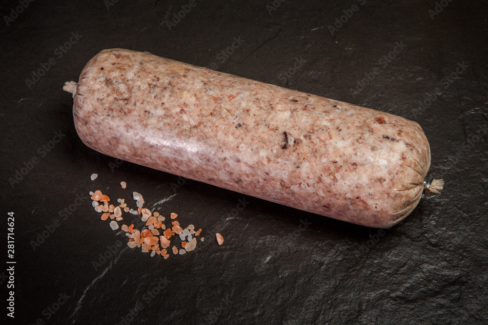 top view on big thick stick of marble sausage with spices top view on big thick stick of marble sausage with spices