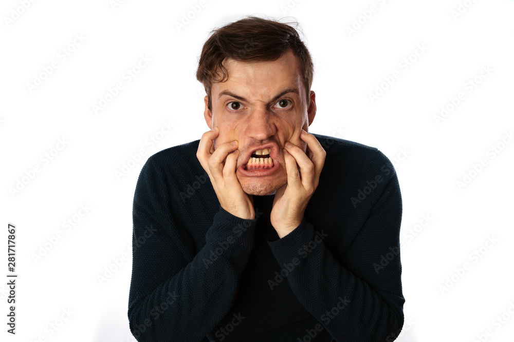 emotional portrait of a crazy man in close-up. concept: the nervous breakdown, mental disease, headaches and migraine. isolated on white background. emotional portrait of a crazy man in close-up. concept: the nervous breakdown, mental disease, headaches and migraine. isolated on white background.