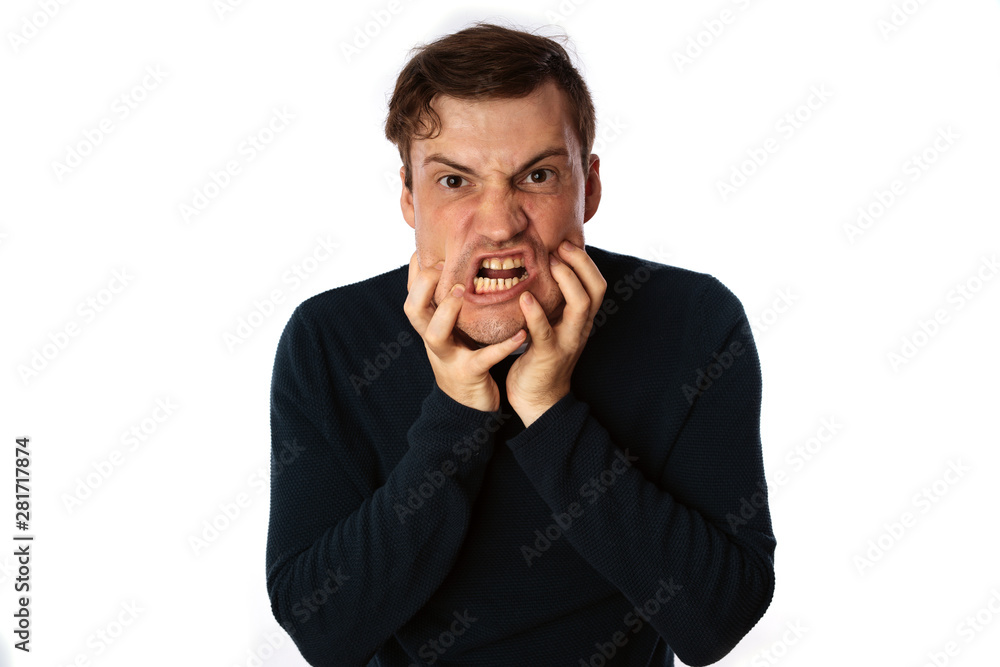 emotional portrait of a crazy man in close-up. concept: the nervous breakdown, mental disease, headaches and migraine. isolated on white background. emotional portrait of a crazy man in close-up. concept: the nervous breakdown, mental disease, headaches and migraine. isolated on white background.
