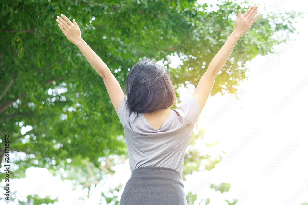 Woman relaxing in morning of a new day, she stretch the muscles refreshing atmosphere at park natural green background . Healthy lifestyle concepts Woman relaxing in morning of a new day, she stretch the muscles refreshing atmosphere at park natural green background . Healthy lifestyle concepts