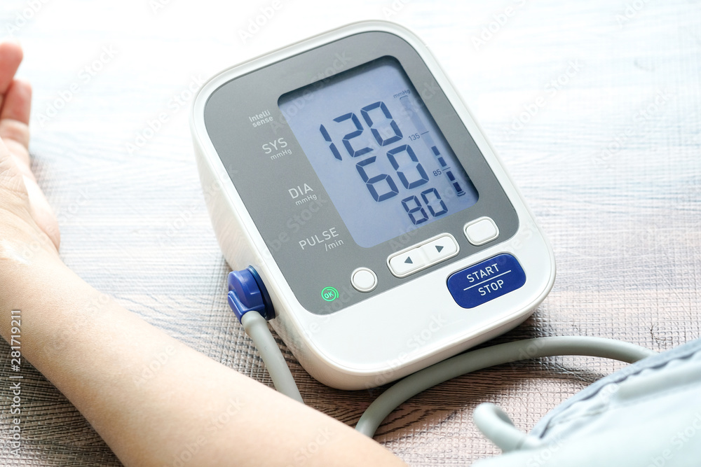 Man check blood pressure monitor and heart rate monitor with digital pressure gauge. Health care and Medical concept Man check blood pressure monitor and heart rate monitor with digital pressure gauge. Health care and Medical concept