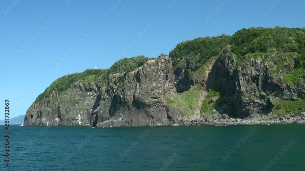 Boat point of view of cliffs towering over Sea of Okhotsk, Japan Boat point of view of cliffs towering over Sea of Okhotsk, Japan