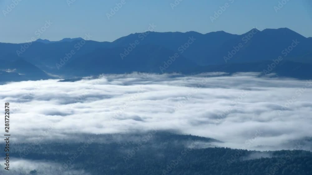 Panning shot of mountains in clouds Panning shot of mountains in clouds