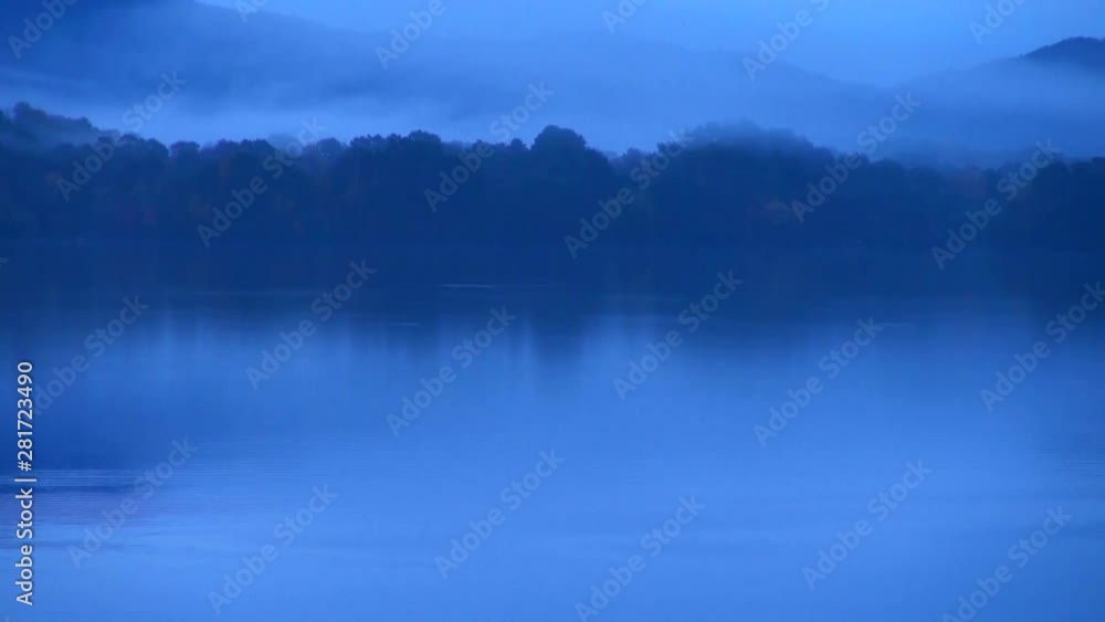 Zoom out of forest reflecting in Lake Sasahara at dawn, Japan Zoom out of forest reflecting in Lake Sasahara at dawn, Japan