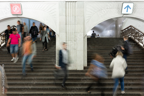 Blurred motion. A lot people on stairs in subway, train station. People climb and descend stairs in large hall. direction human flow, crowd