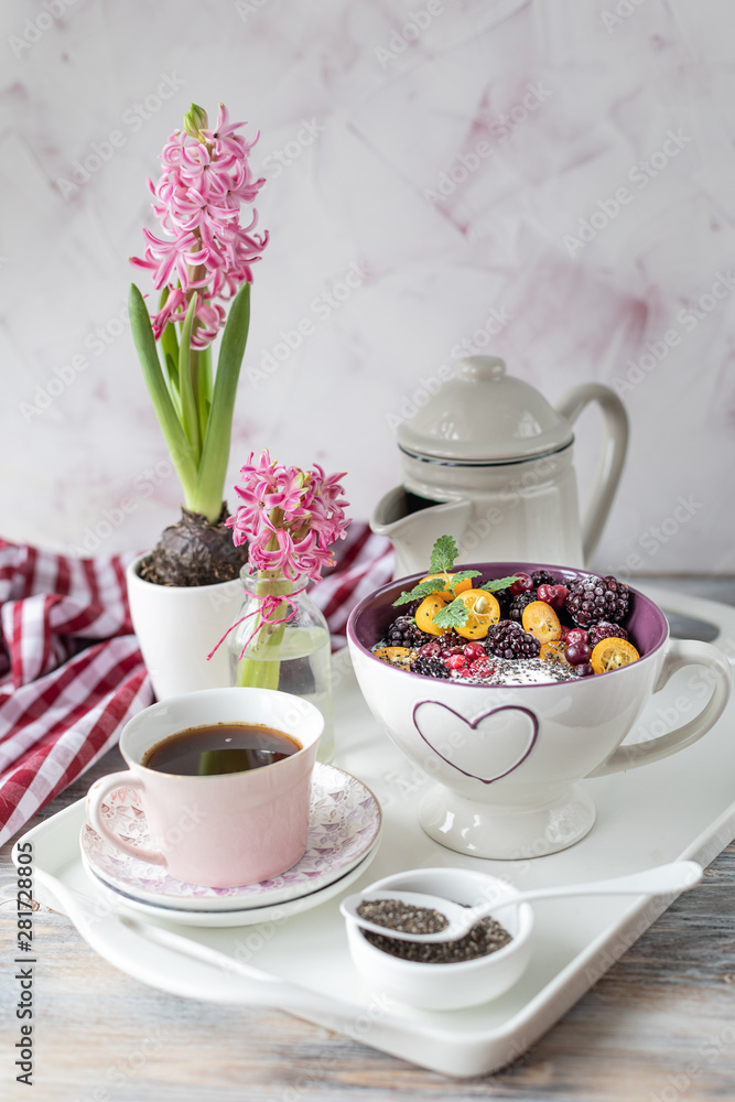 Homemade granola with nuts, chia seeds and fruit in a breakfast mug. Light photo. Homemade granola with nuts, chia seeds and fruit in a breakfast mug. Light photo.