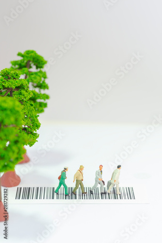 Photography Miniature toys a group of people crossing a road with tree toys on the sidewalk - road safety concept