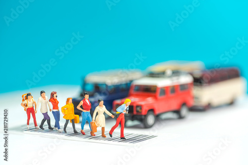 Miniature toys a group of women crossing a road - road safety concept.