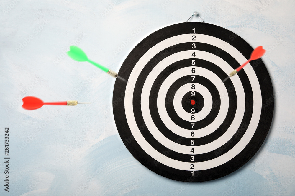 Color darts and board on light blue background Color darts and board on light blue background