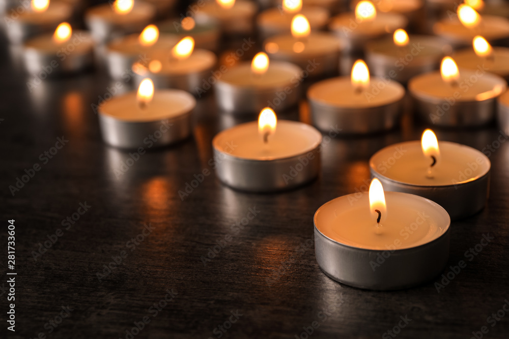 Burning candles on wooden table, space for text. Symbol of sorrow Burning candles on wooden table, space for text. Symbol of sorrow