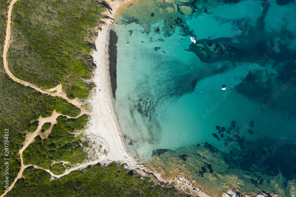 View from above, stunning aerial view of a wild beach bathed by a beautiful turquoise sea. Costa Smeralda (Emerald Coast) Sardinia, Italy.