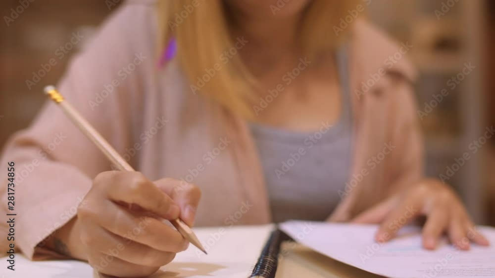 Asian student women reading books in library at university. Young undergraduate girl do homework, read textbook, study hard for knowledge on lecture desk at college campus overtime night. Slow motion. Asian student women reading books in library at university. Young undergraduate girl do homework, read textbook, study hard for knowledge on lecture desk at college campus overtime night. Slow motion.