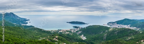 Montenegro, XXL panorama of city budva at the coast at the ocean from above green mountains covered by forest and trees nature landscape