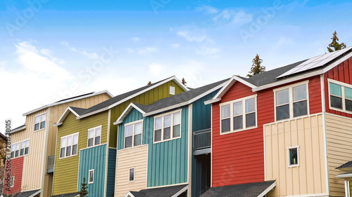 Panorama Houses with balconies and porches against blue sky and clouds on a sunny day