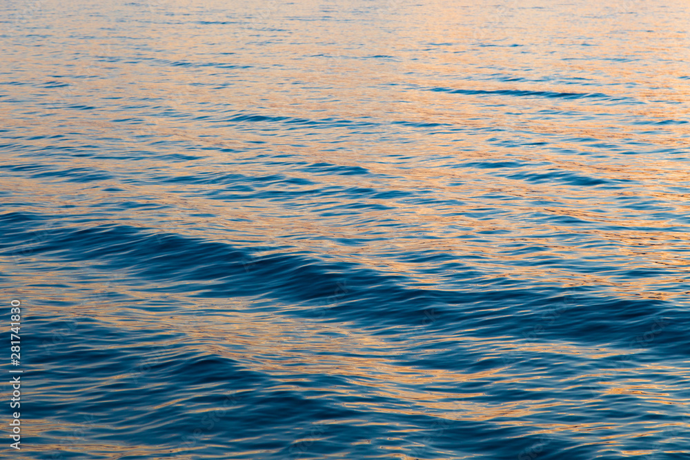 Naklejka premium Blue clear water. Beautiful blue sea wave photograph close up. Beach vacation at sea or ocean.