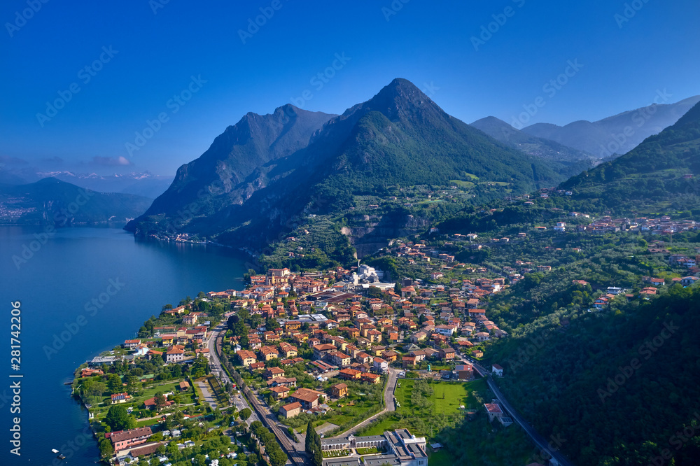 Flying over lake Iseo north of Italy. Panoramic view of the alps. A good place to rest in travel.