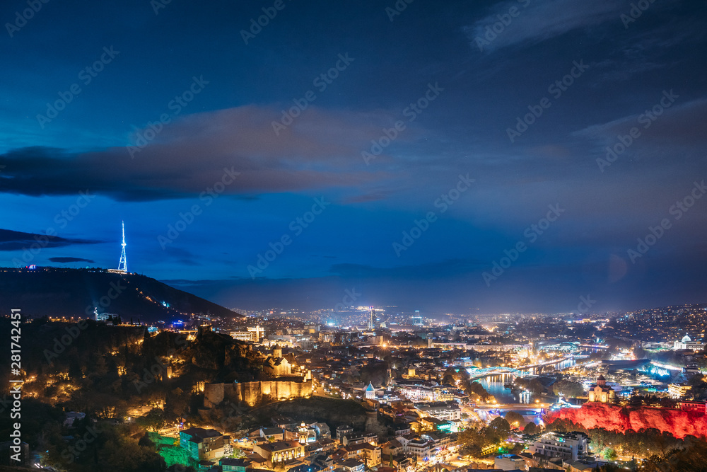 Tbilisi, Georgia. Top View Of Georgian Capital City Skyline Cityscape In Night Illuminations. Georgian Capital Skyline Cityscape
