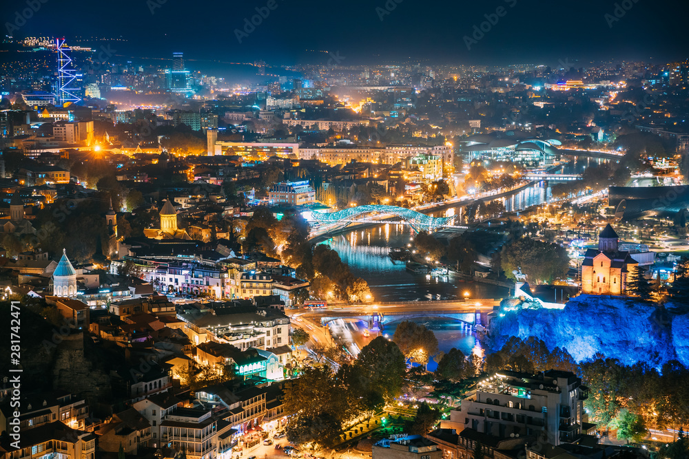 Tbilisi, Georgia. Top View Of Georgian Capital City Skyline Cityscape In Night Illuminations