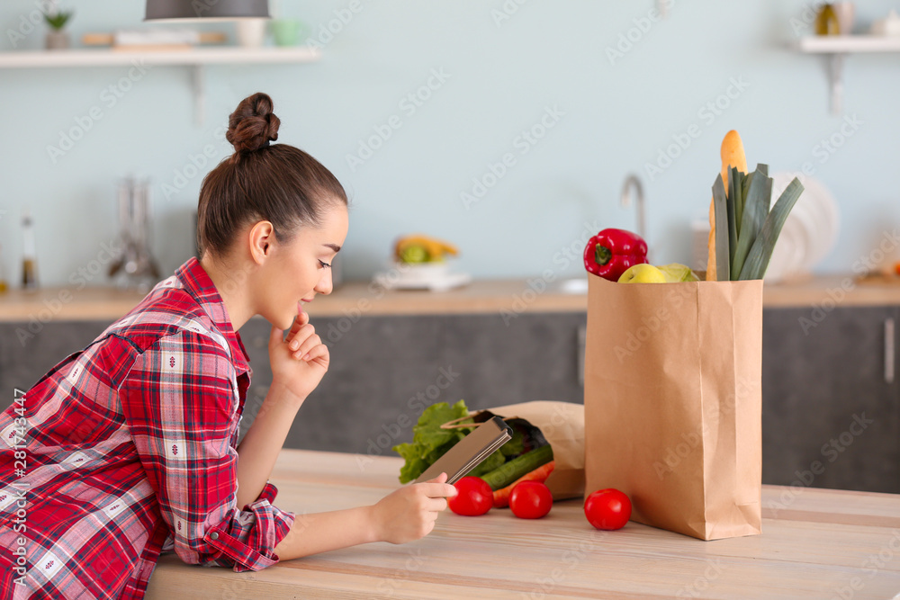 Beautiful woman with fresh products in kitchen at home Beautiful woman with fresh products in kitchen at home