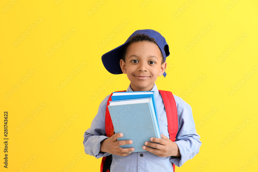 Cute African-American schoolboy on color background Cute African-American schoolboy on color background