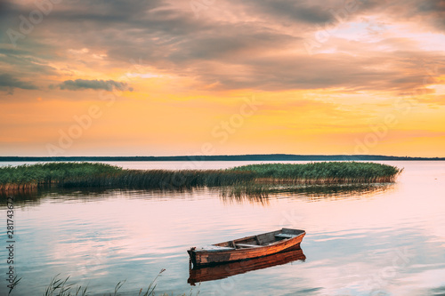 Braslaw Or Braslau, Vitebsk Voblast, Belarus. Wooden Rowing Fishing Boat In Beautiful Summer Sunset On The Dryvyaty Lake. This Is The Largest Lake Of Braslav Lakes. Typical Nature Of Belarus
