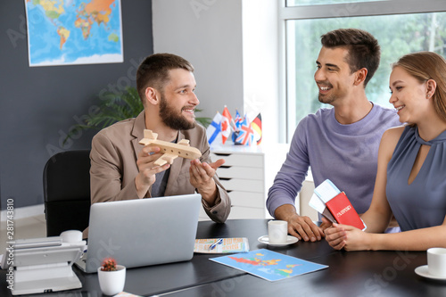 Male travel agent working w...