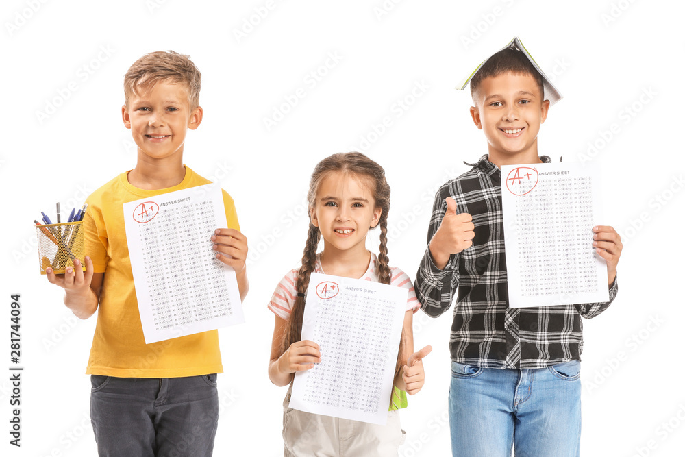 Happy children with answer sheets for school test on white background Happy children with answer sheets for school test on white background