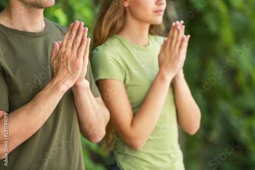 Religious couple praying to...