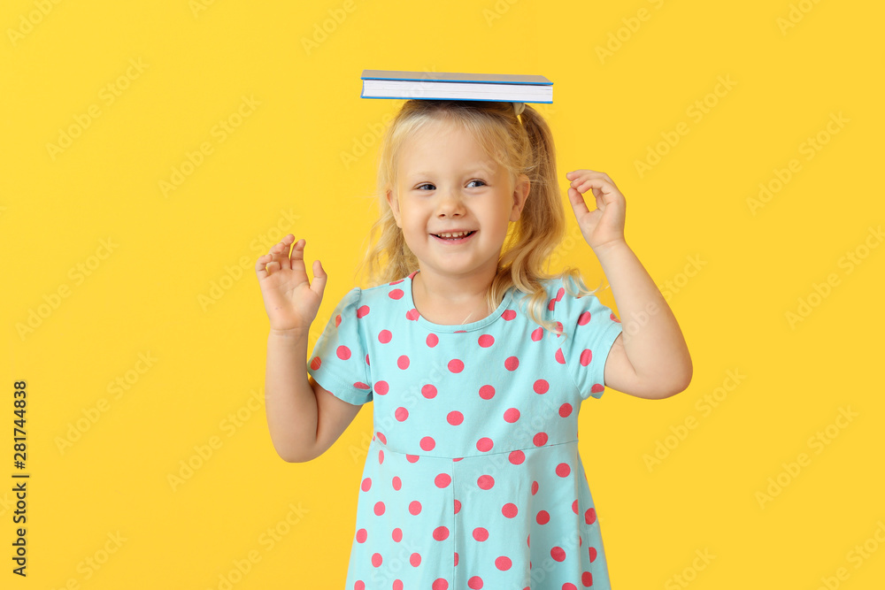 Cute little girl with book on color background - obrazy, fototapety, plakaty 
