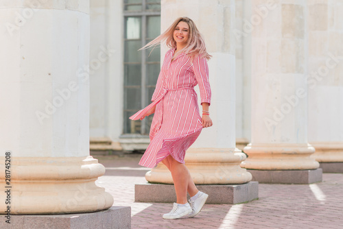 Nice american girl from next door in cotton dress walk in central park. Smiling and laughing have fun time 