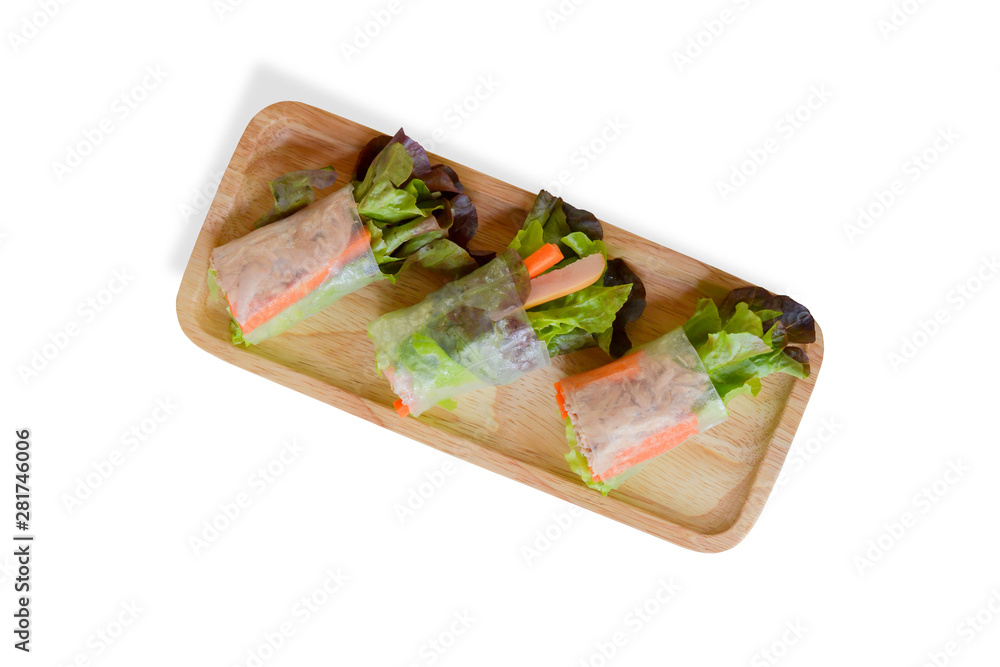 Top view three fresh organic green vegetable (lettuce and carrot slice) rice wraps with tuna, sausage on wooden dish isolated on white background. Healthy Thai food for loose weight. Clipping path Top view three fresh organic green vegetable (lettuce and carrot slice) rice wraps with tuna, sausage on wooden dish isolated on white background. Healthy Thai food for loose weight. Clipping path