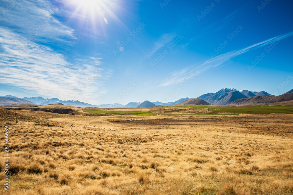 Fototapeta premium Landscape Nature Photograph of Mountains In New Zealand, Blue Sky With Clouds, Beautiful Outdoor Wilderness Adventure Background
