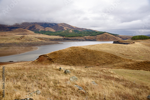 Mountain reservoir in the fall on a foggy cloudy autumn day with clouds in the sky. photo