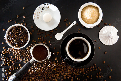 Coffee scene flat lay beans porta filter black coffee cup sugar and macaroon biscuit
