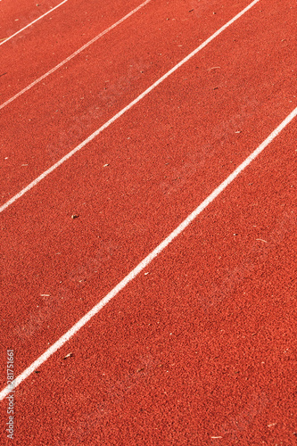 closeup of athletic red running tracks whit white lines