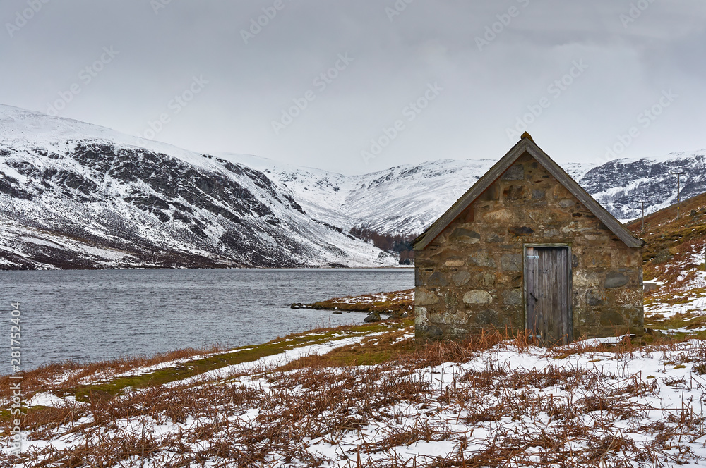 An Old Victorian Fishing Bothy besides the banks of Loch Lee in the Angus Glens of Scotland, on one cold and grey Winters day.