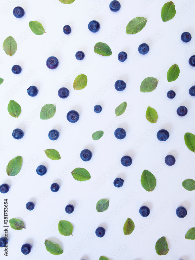 Blueberries and small green leaves on a white background Blueberries and small green leaves on a white background