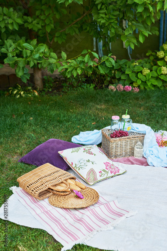 picnic decor with lavender, baskets on the grass in the summer in the garden